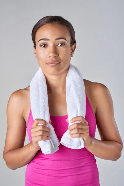 Sporty woman with towel after exercise