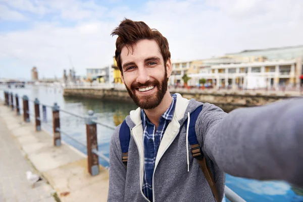 Backpacker man taking selfie on holiday