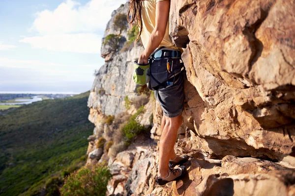 Man climbing up a steep mountain