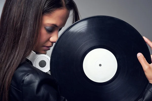 Woman dj with vinyl record and headphones