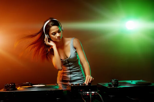 Woman dj playing music at party