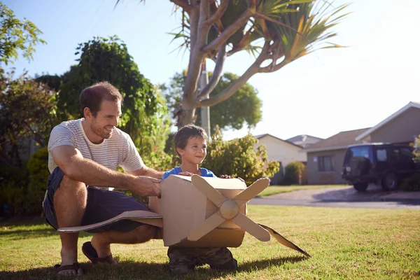 Son and dad with toy aeroplane