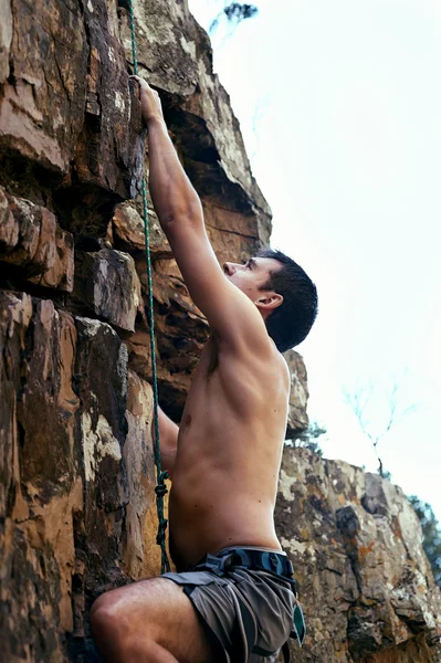 Man rock climbing  with harness on