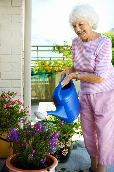 Retired woman watering her plants