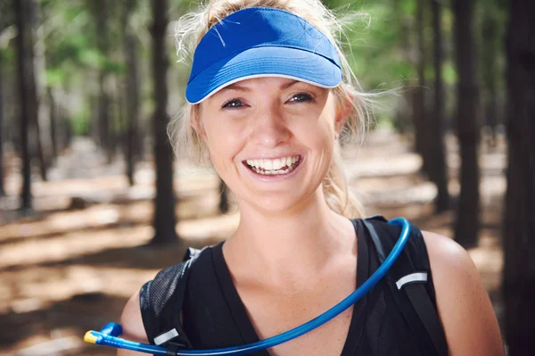 Woman smiling while trail running