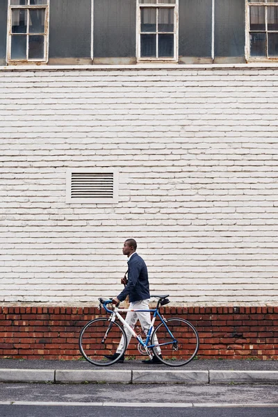 African man with bicycle walking