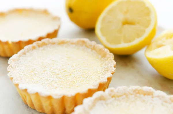 Three lemon tarts dusted