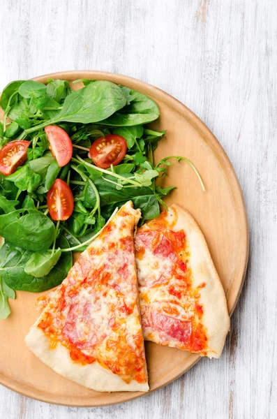 Slices of pizza with side salad