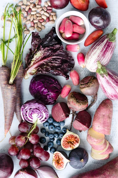 Assorted purple toned fruits and vegetables a