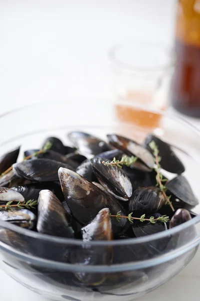 Raw fresh mussles with thyme sprigs