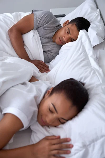 Mixed race couple sleeping