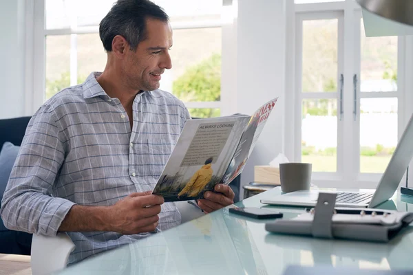 Businessman reading business magazine