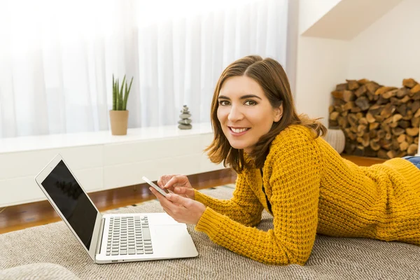 Woman at home working with a laptop