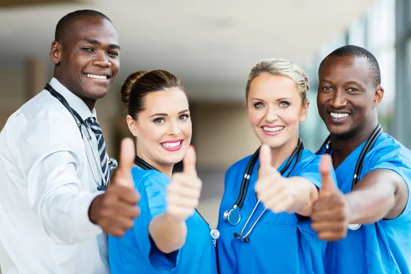 Healthcare workers showing thumbs up