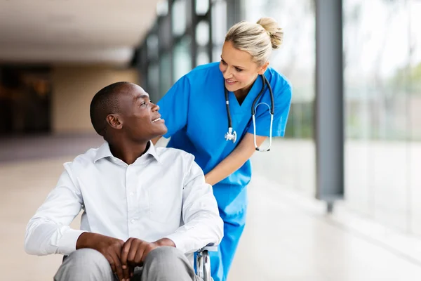 Nurse with male patient in wheelchair