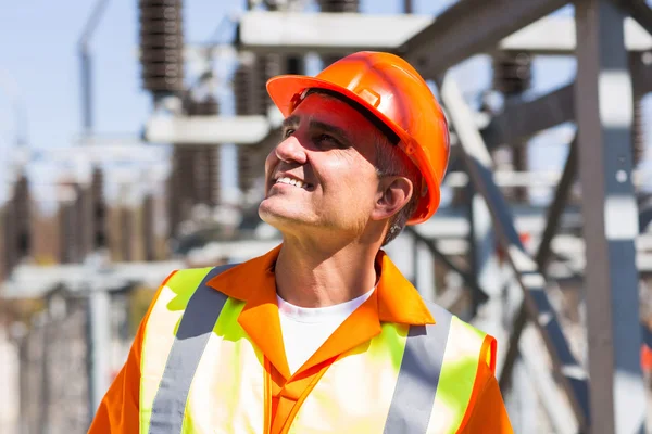 Mature electrician in electrical substation