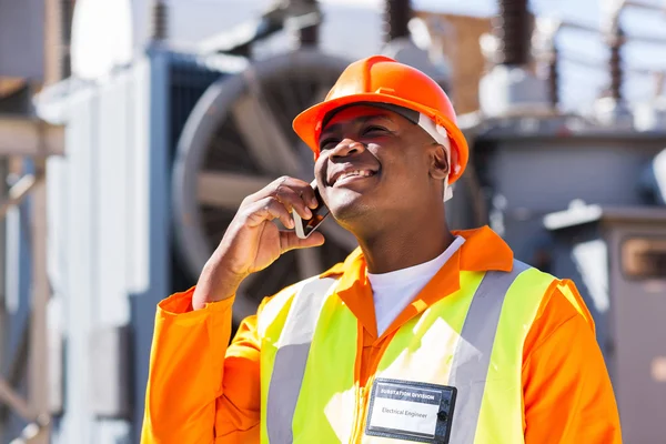 African electrician using cell phone