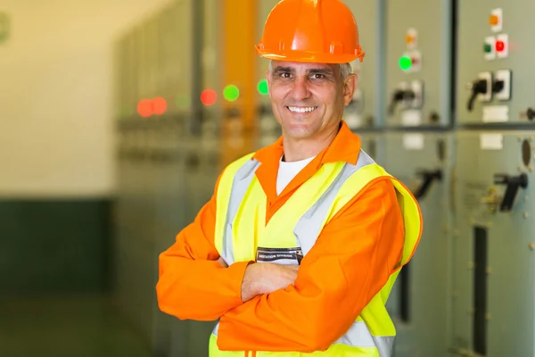 Middle-aged electrical engineer with arms crossed