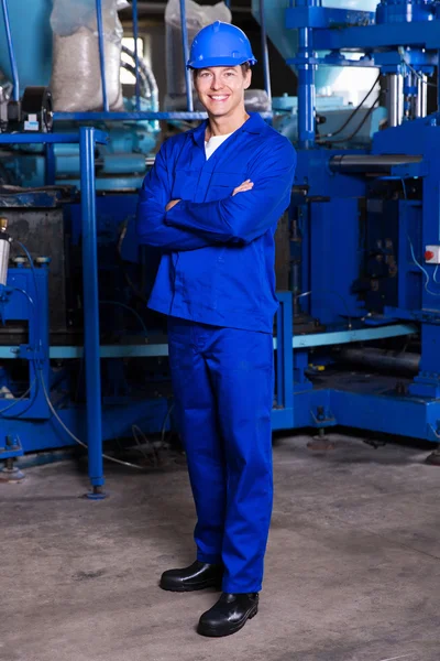 Factory technician with crossed arms