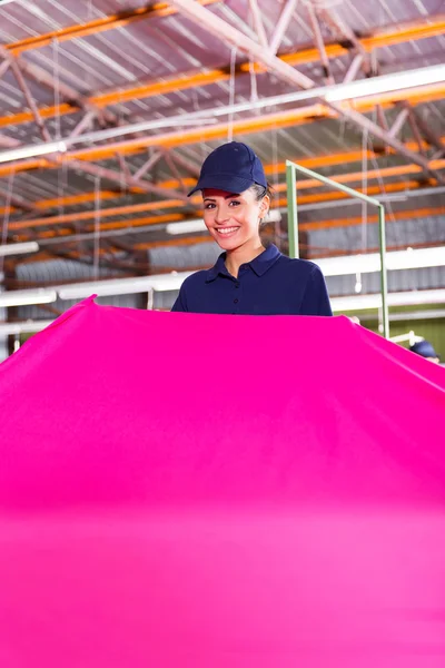 Worker holding large fabric