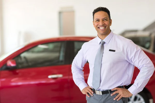 Middle aged vehicle sales consultant