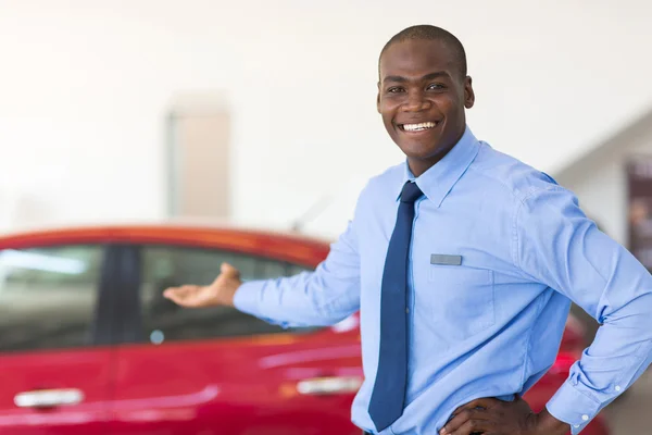 African car salesman presenting new cars