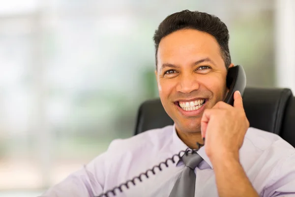 Businessman using landline phone