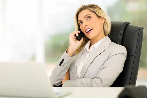 Businesswoman talking on landline phone