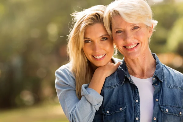 Mature mother and  daughter  smiling