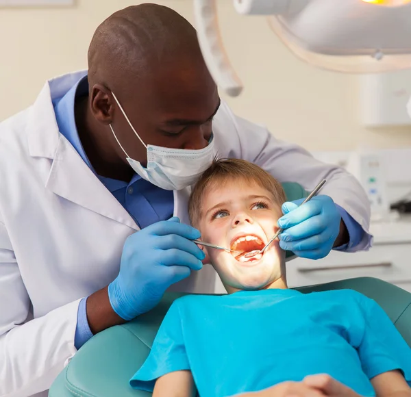 Dentist working on little patient