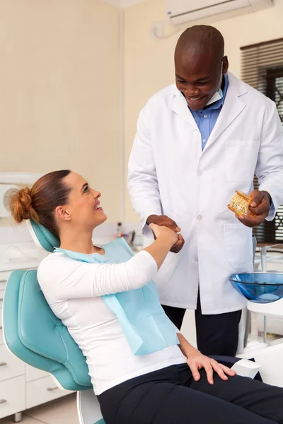 Woman shaking hands with dentist
