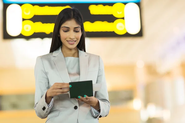 Businesswoman checking her flight ticket