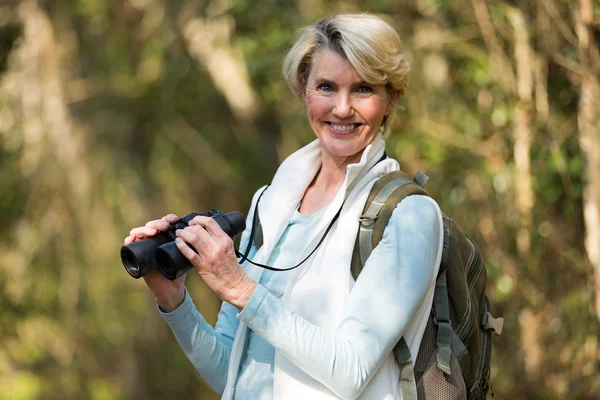 Female hiker with binoculars