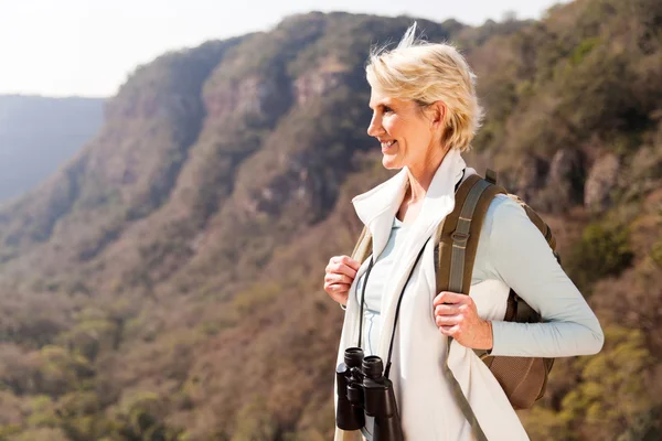 Woman on mountain with binoculars