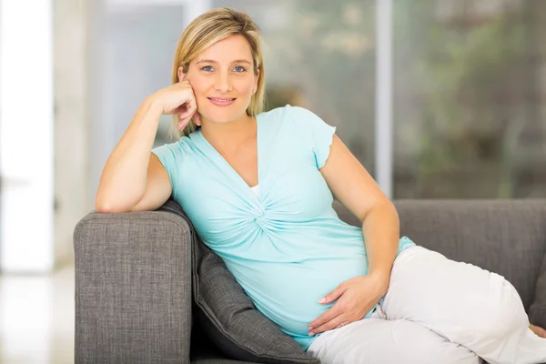 Pregnant woman sitting on sofa