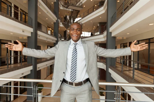 African businessman with arms outstretched