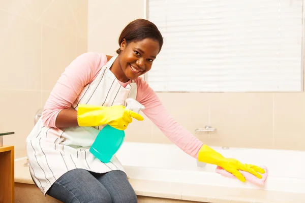 Housewife cleaning up bathtub