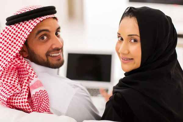 Muslim couple using laptop computer