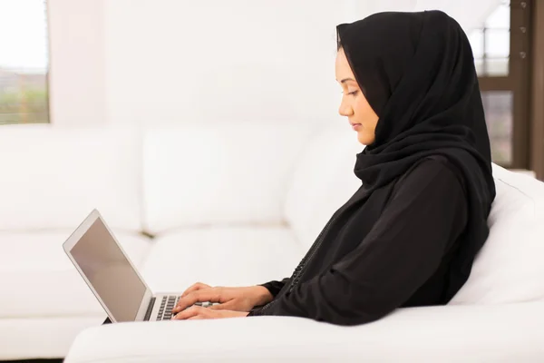 Middle eastern woman using laptop