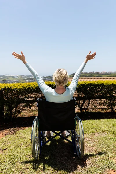 Disabled woman sitting outdoors