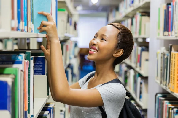 Student searching for book in library