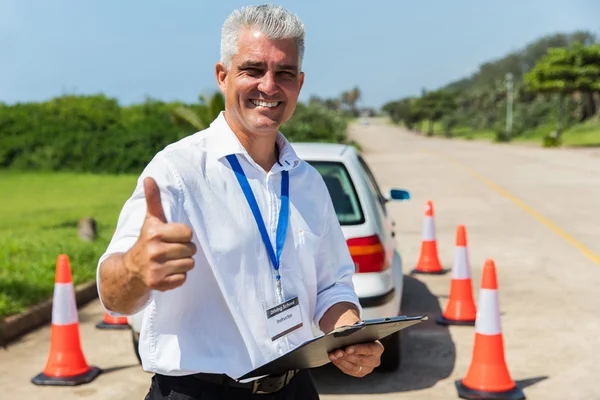 Driving instructor with clipboard