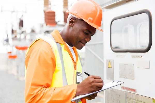 Electrician working in electrical substation