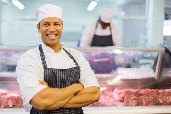 Male butcher with arms folded