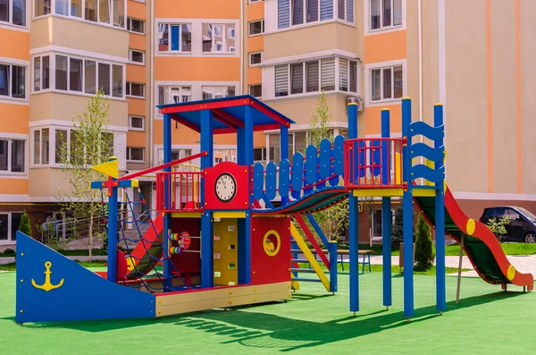 New colorful children\'s play complex in the courtyard of a multi