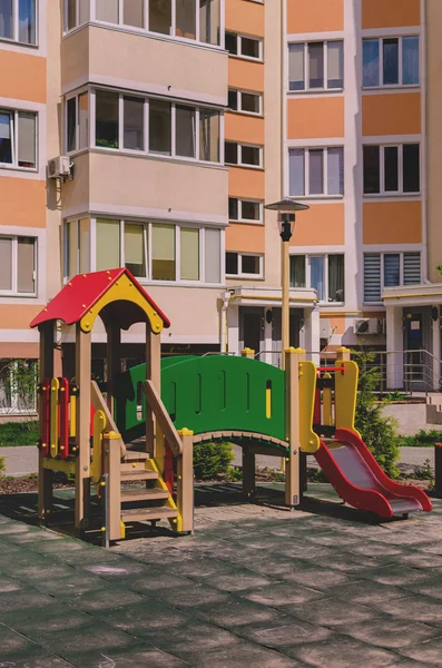 New colorful children's play complex in the courtyard of a multi