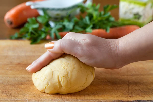 Hand On Pasta Dough On A Cutting Board