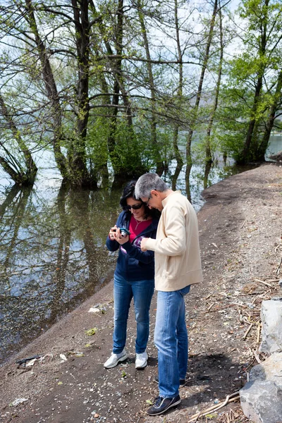 Couple Watching Photos Taken With Smartphone