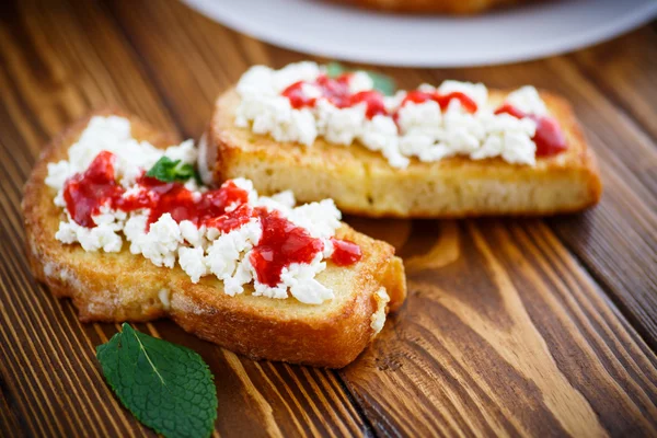 Fried in batter toast with cream cheese and jam