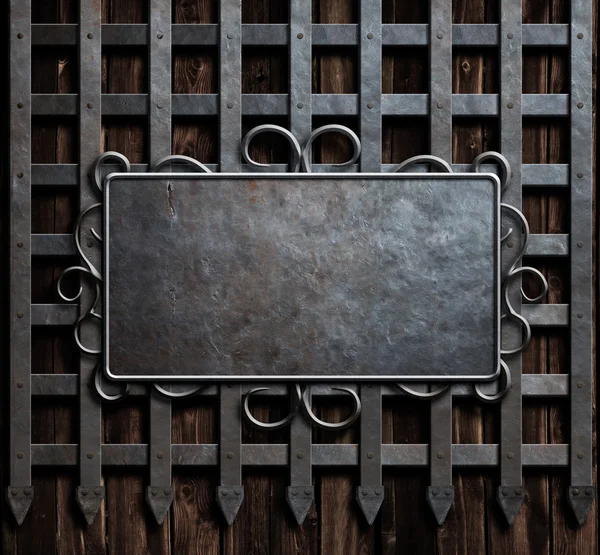 Mteal plate on medieval castle gate or wall background